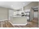 Open kitchen with granite countertops, stainless steel appliances, and a breakfast bar at 12817 Sw 77Th Cir, Ocala, FL 34473