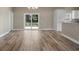 Bright open living space with sliding glass doors and wood-look flooring at 12817 Sw 77Th Cir, Ocala, FL 34473
