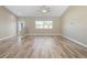 Large living room featuring wood floors, natural light, and open space for furniture arrangement at 12817 Sw 77Th Cir, Ocala, FL 34473