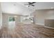 Open-concept living room with hardwood floors, modern lighting, and sliding glass doors to the backyard at 12817 Sw 77Th Cir, Ocala, FL 34473