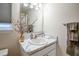 Updated bathroom with marble countertop, neutral paint, and stylish decor at 1282 Cottage Cir, Tavares, FL 32778