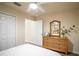 Cozy bedroom with wood-look floors, ceiling fan, wicker dresser and mirror over queen bed at 1282 Cottage Cir, Tavares, FL 32778