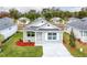 Charming home with light blue siding, gray roof, landscaped front yard, and a welcoming entrance at 1282 Cottage Cir, Tavares, FL 32778