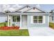 Charming single-story home with light blue siding, a well-manicured lawn, and a welcoming front entrance at 1282 Cottage Cir, Tavares, FL 32778