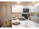 Updated kitchen featuring white cabinets, a marble countertop, and a breakfast bar at 1282 Cottage Cir, Tavares, FL 32778