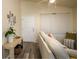Bright living room featuring wood-look floors, vaulted ceilings, and comfortable seating arrangement with natural light at 1282 Cottage Cir, Tavares, FL 32778