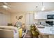 Open-concept living space featuring a modern kitchen with a breakfast bar and a comfortable living room area at 1282 Cottage Cir, Tavares, FL 32778