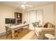Comfortable home office with bookshelf, window, and neutral decor, perfect for productivity at 1282 Cottage Cir, Tavares, FL 32778