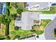 Aerial view of home displaying roof, lanai, landscaping, and driveway situated in the neighborhood at 1306 Pedro Ct, The Villages, FL 32159