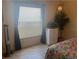 A charming bedroom boasts laminate flooring, a large window and ample natural light at 1306 Pedro Ct, The Villages, FL 32159
