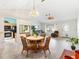 Open-concept dining and living area with view of kitchen, and tile flooring at 1306 Pedro Ct, The Villages, FL 32159