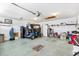 Spacious garage featuring a golf cart, ample storage, and organized shelving for a functional space at 1306 Pedro Ct, The Villages, FL 32159