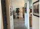 Hallway view of living area with wood-look tile floors, neutral paint, and artwork at 1306 Pedro Ct, The Villages, FL 32159
