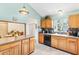 This quaint kitchen boasts light wood cabinets, undermount sink and an open concept dining area at 1306 Pedro Ct, The Villages, FL 32159