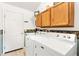 Spacious laundry room with washer, dryer and storage cabinets at 1306 Pedro Ct, The Villages, FL 32159