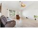 Cozy living room featuring tile floors, a large window, and comfortable seating at 1306 Pedro Ct, The Villages, FL 32159