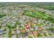 Scenic aerial view of the neighborhood with a lake and golf course, marked with a locator pin at 1307 Galindo Pl, The Villages, FL 32159
