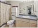 Bathroom features a vanity with solid surface countertop, a toilet and shower with curtain at 1307 Galindo Pl, The Villages, FL 32159