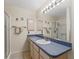 Bathroom features a vanity with solid surface countertop, and a glass-enclosed shower at 1307 Galindo Pl, The Villages, FL 32159