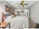 Bedroom boasts a ceiling fan, carpeted floors, walk-in closet and an attached bath at 1307 Galindo Pl, The Villages, FL 32159