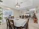 Dining room features a modern light fixture and easy access to the main living area and kitchen at 1307 Galindo Pl, The Villages, FL 32159