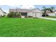Charming home exterior with a spacious green lawn, mature landscaping, and welcoming curb appeal at 1307 Galindo Pl, The Villages, FL 32159