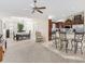 Open concept living room with a large dining area with adjacent kitchen with breakfast bar at 1307 Galindo Pl, The Villages, FL 32159