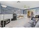 Living area features nautical decor, ceiling fan, and french door access to another room at 1307 Galindo Pl, The Villages, FL 32159