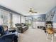 Comfortable living room with nautical decor, a ceiling fan, and access to outdoor spaces at 1307 Galindo Pl, The Villages, FL 32159