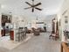 Open concept living space features tile flooring, high ceilings, and access to front door and kitchen at 1307 Galindo Pl, The Villages, FL 32159