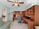 Office area features a built-in desk, shelving, and a ceiling fan at 1307 Galindo Pl, The Villages, FL 32159