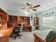 Office area features a built-in desk, shelving and a ceiling fan at 1307 Galindo Pl, The Villages, FL 32159