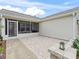 View of a covered patio with brick flooring and privacy screen at 1307 Galindo Pl, The Villages, FL 32159