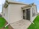 Corner shot of back exterior with a patio, sliding door, neutral siding, and well maintained lawn at 1307 Galindo Pl, The Villages, FL 32159