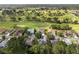 Aerial view featuring homes backing onto a golf course with mature landscaping at 13190 Se 93Rd Cir, Summerfield, FL 34491