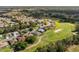 Aerial view of a community with lush golf course, manicured lawns, and beautifully landscaped homes at 13190 Se 93Rd Cir, Summerfield, FL 34491
