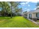The back yard has green grass with a patio with seating and a grill at 13190 Se 93Rd Cir, Summerfield, FL 34491