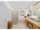 Bathroom featuring double sinks, a soaking tub, and a separate glass door shower at 13190 Se 93Rd Cir, Summerfield, FL 34491