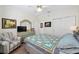 Inviting bedroom with a ceiling fan, closet, and colorful quilt at 13190 Se 93Rd Cir, Summerfield, FL 34491