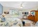 Bright bedroom with large window, wood floors, and stylish decor at 13190 Se 93Rd Cir, Summerfield, FL 34491