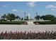 Beautiful community entrance fountain, featuring manicured landscaping and palm trees, adding to the scenic view at 13190 Se 93Rd Cir, Summerfield, FL 34491