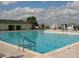 Large outdoor community pool with clear blue water, lounge chairs, and sunny skies, perfect for relaxation at 13190 Se 93Rd Cir, Summerfield, FL 34491
