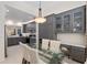 Dining area showcasing a glass table, built-in cabinets, and an open layout to the kitchen at 13190 Se 93Rd Cir, Summerfield, FL 34491