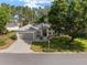 Beautiful one-story home with a well-kept lawn, a two-car garage, and mature trees at 13190 Se 93Rd Cir, Summerfield, FL 34491