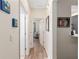 Hallway with doorways leading to rooms and decorated with vibrant wall art at 13190 Se 93Rd Cir, Summerfield, FL 34491
