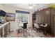 Bright home office with a large window, built-in storage, and a comfortable workspace with stylish area rug at 13190 Se 93Rd Cir, Summerfield, FL 34491