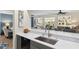 Updated kitchen featuring gray cabinetry, stainless steel appliances, and an eat-in bar at 13190 Se 93Rd Cir, Summerfield, FL 34491