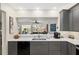 Modern kitchen featuring gray cabinetry, stainless steel appliances, and an eat-in bar at 13190 Se 93Rd Cir, Summerfield, FL 34491