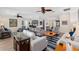 Open concept living room with hardwood floors, comfortable seating, and natural light at 13190 Se 93Rd Cir, Summerfield, FL 34491