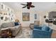Bright living area featuring hardwood floors and access to the kitchen at 13190 Se 93Rd Cir, Summerfield, FL 34491